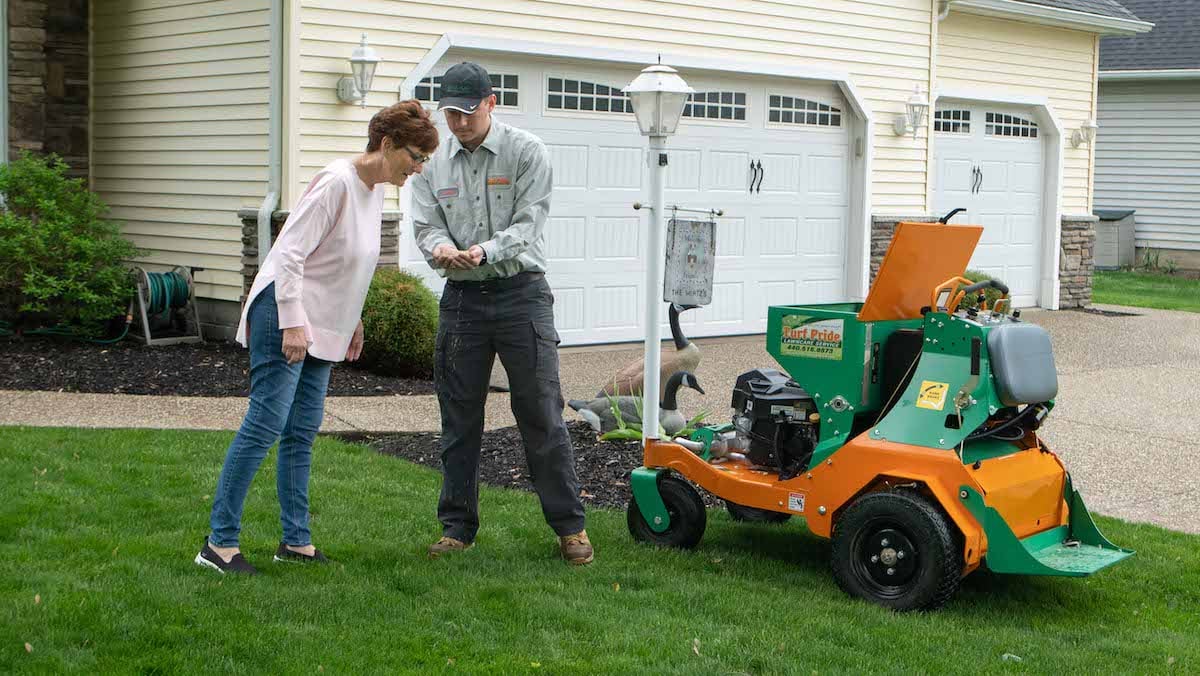 Technician on lawn with customer