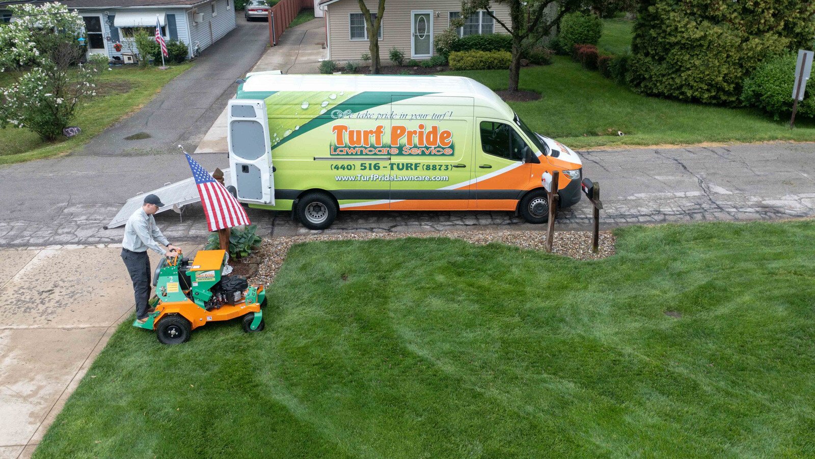 beautiful green lawn with crew on machine