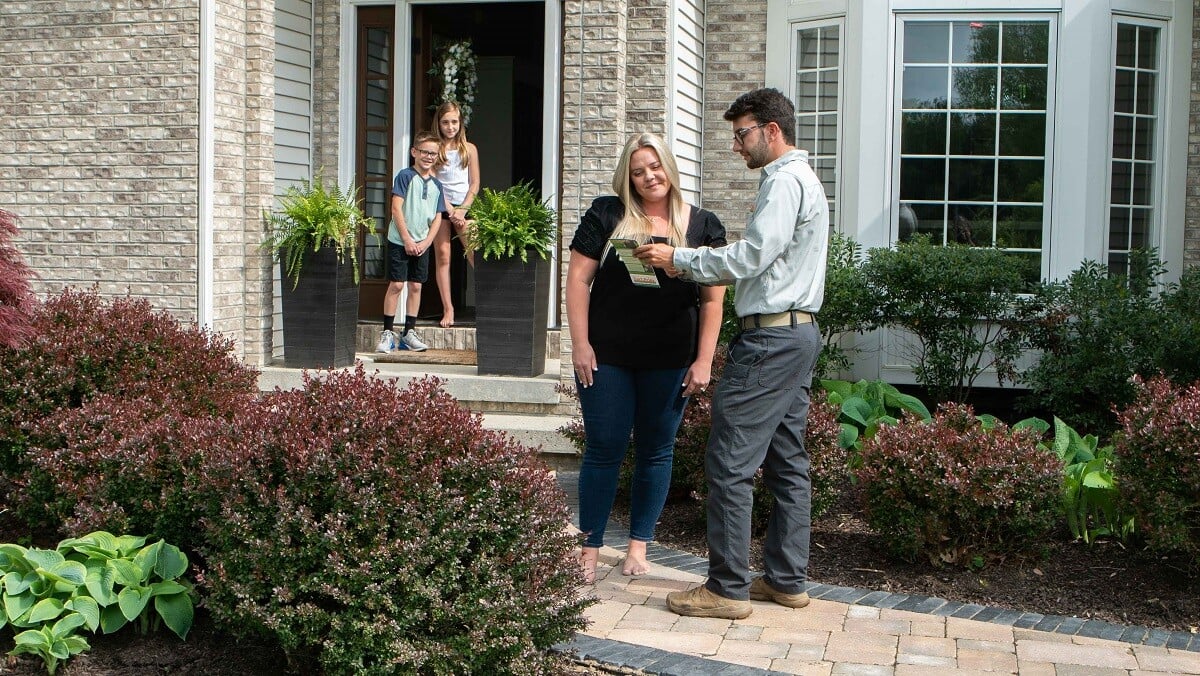 technician going over lawn care options with client