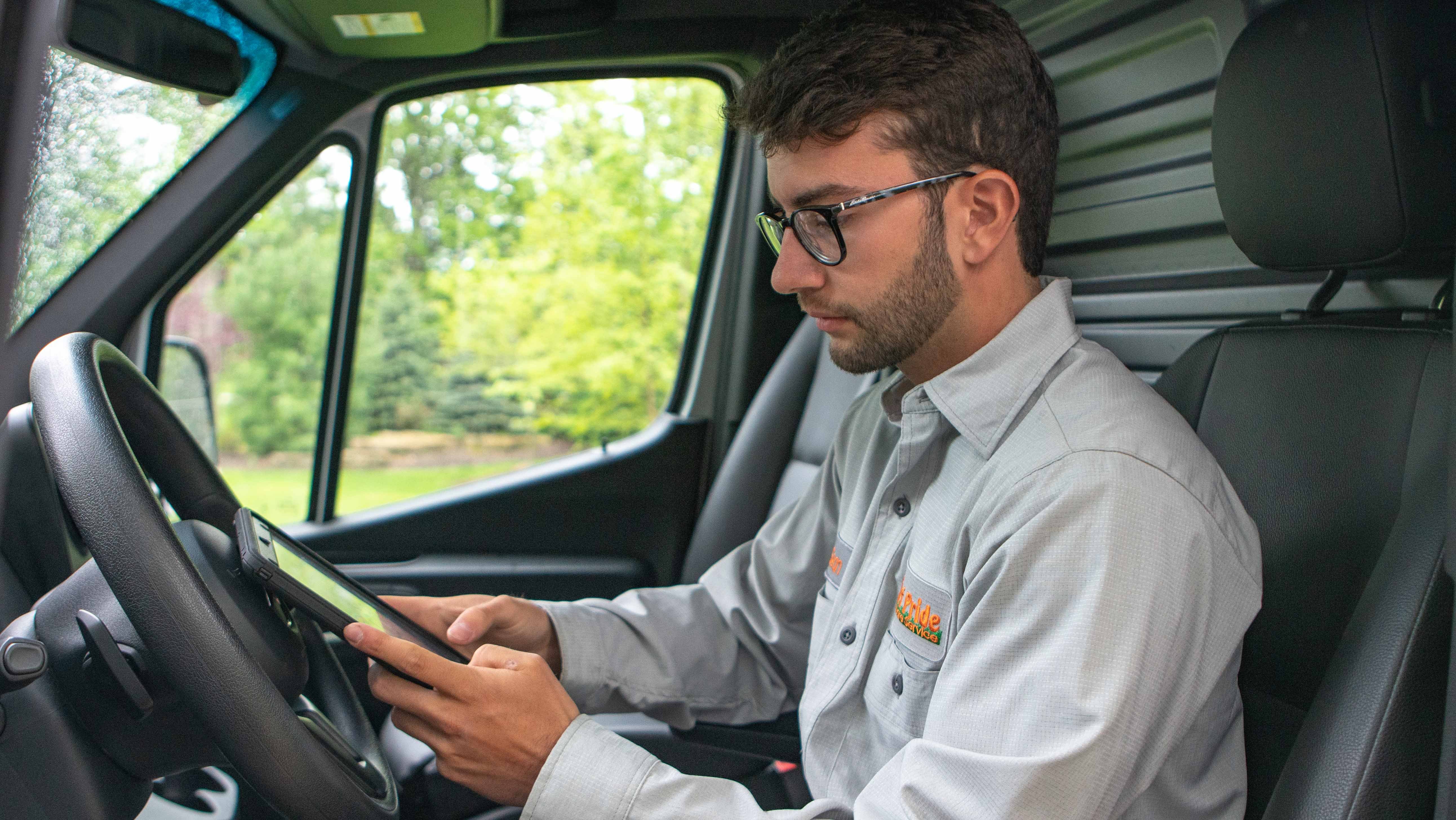 technician in truck texting customer on tablet
