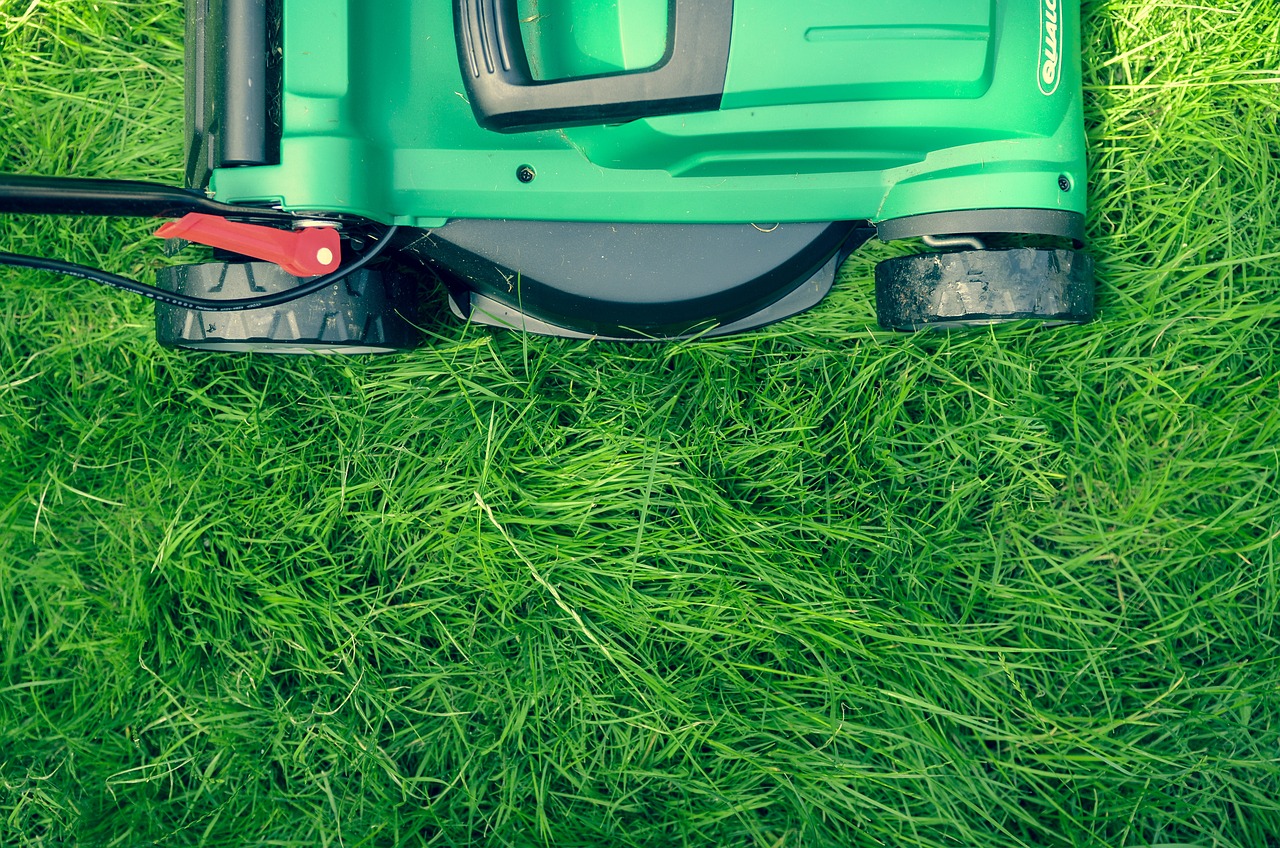 lawn mower cutting long grass