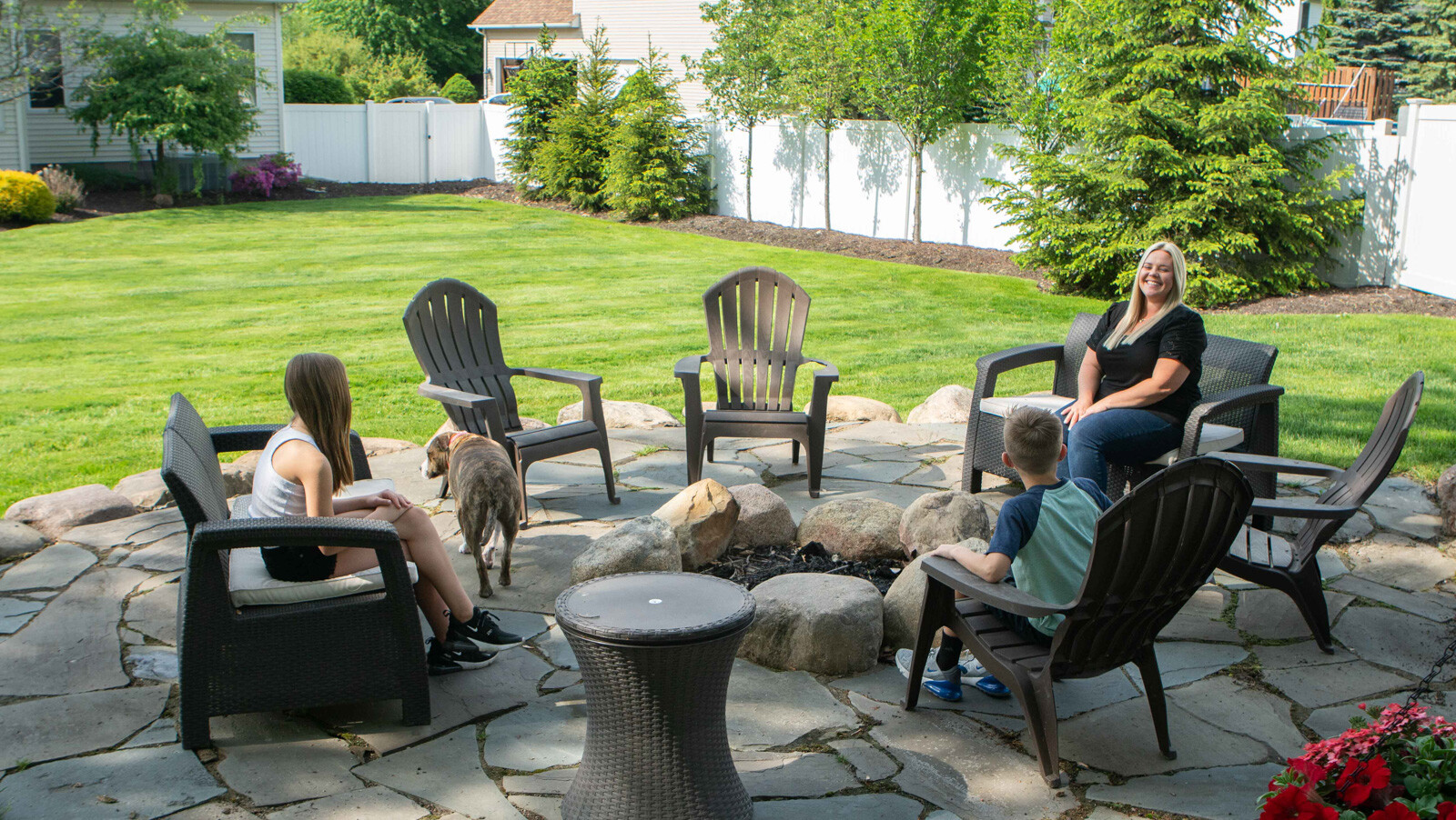 family sitting by bonfire pest free