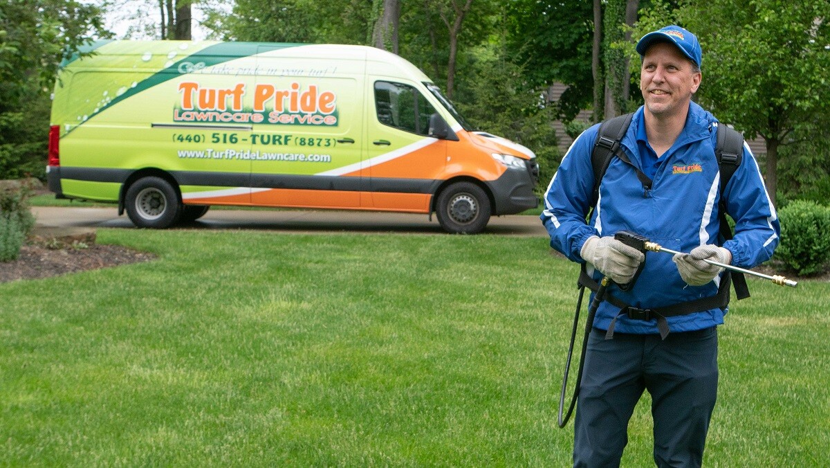 technician spraying home for pests 