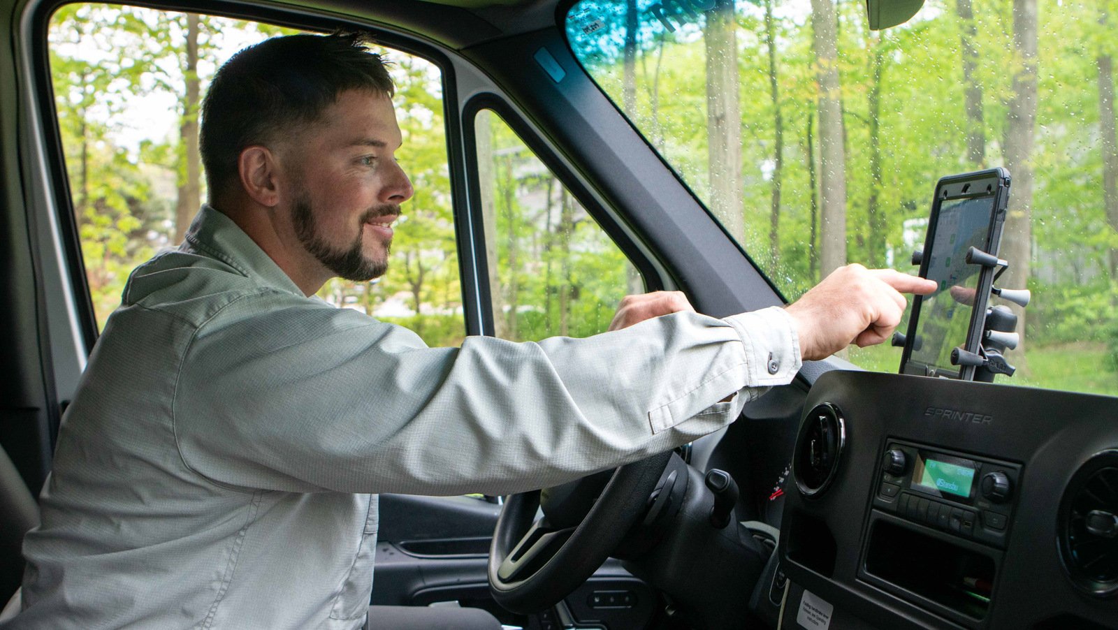 technician in truck using technology 