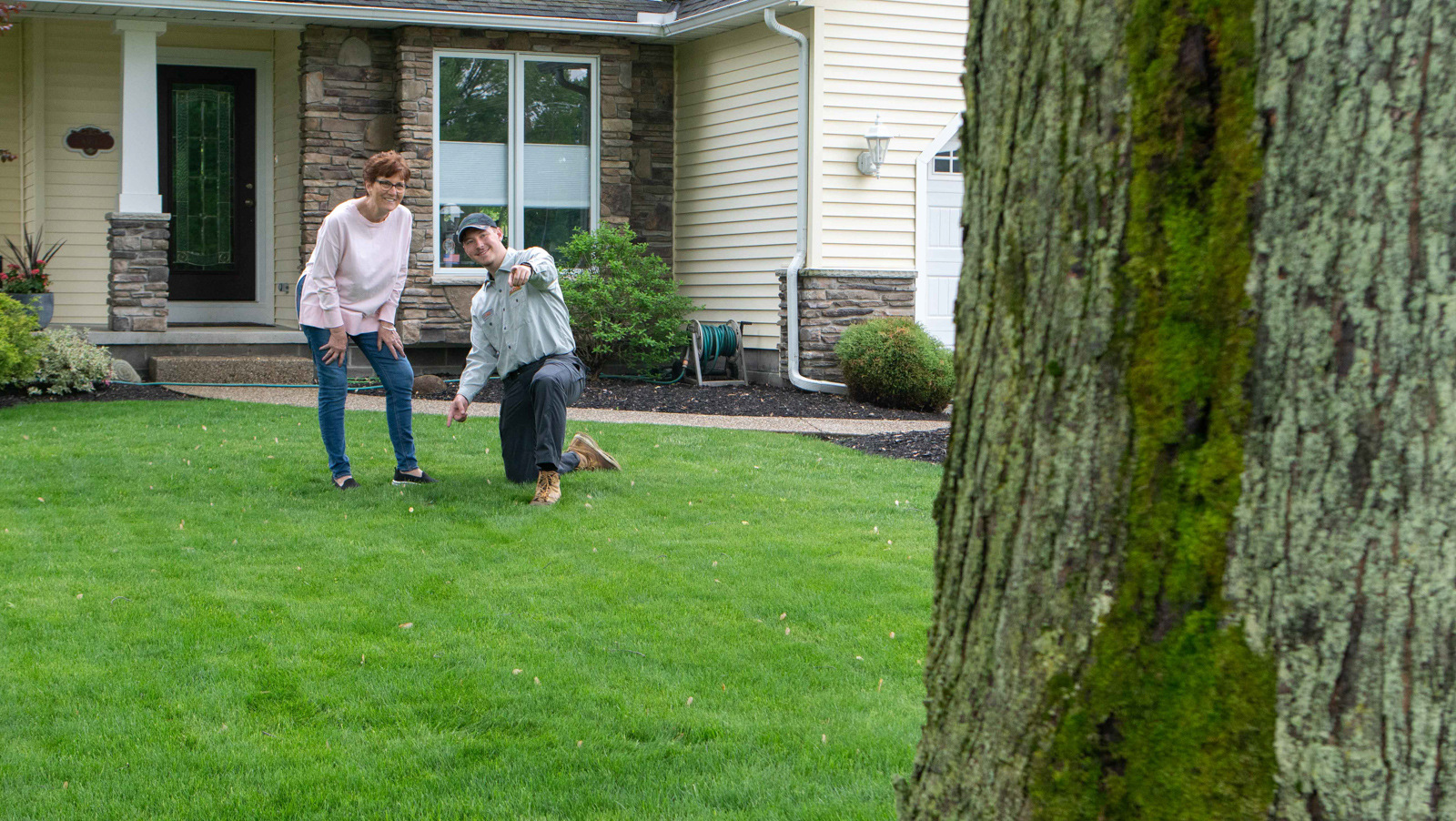 technician showing customer lawn 