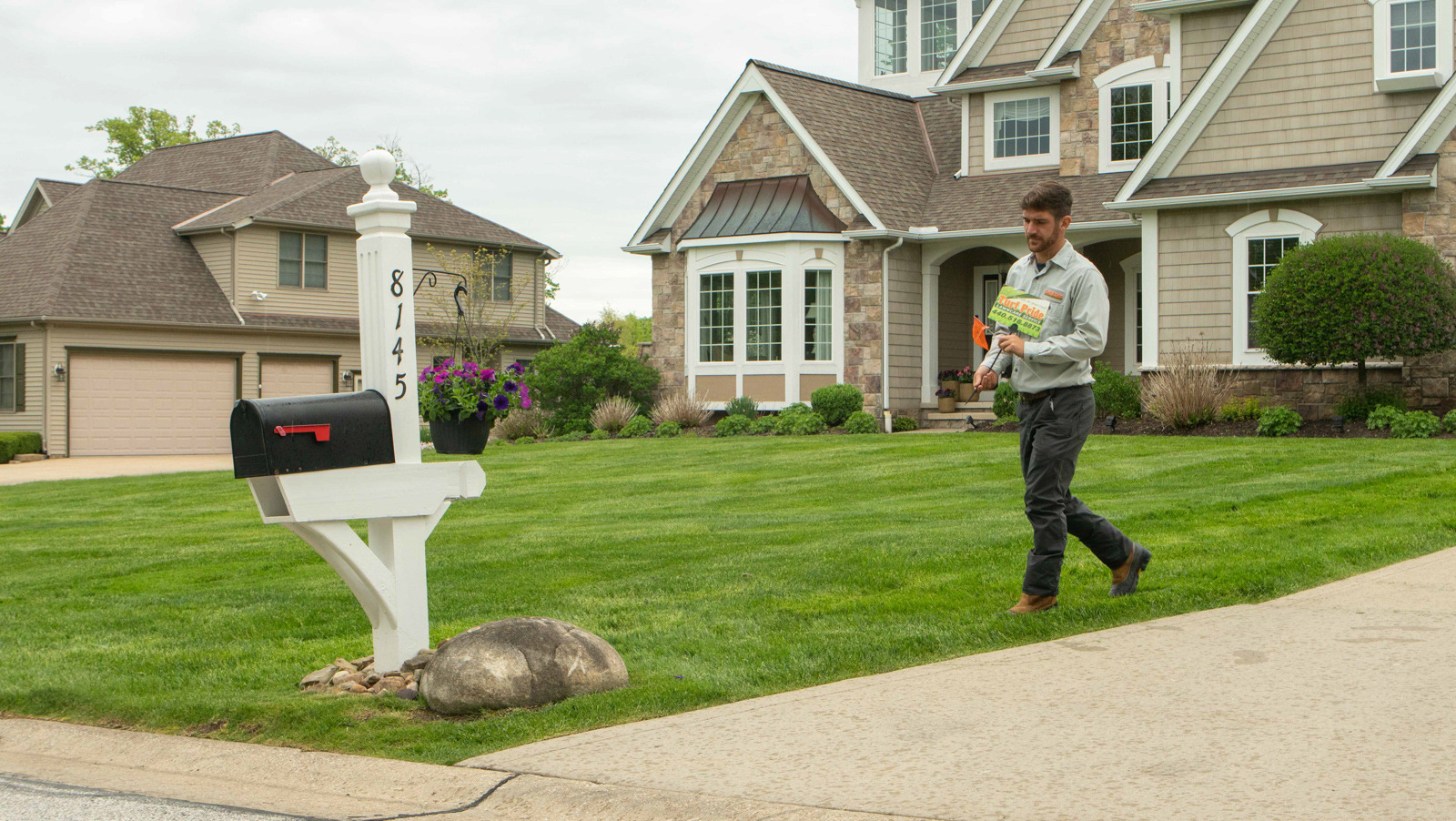 Lawn technician carrying sign 