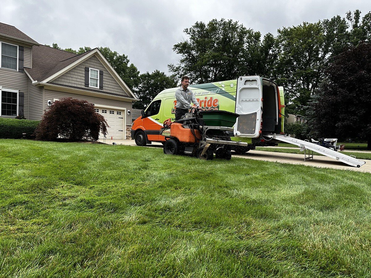 team memeber overseeding green lawn 